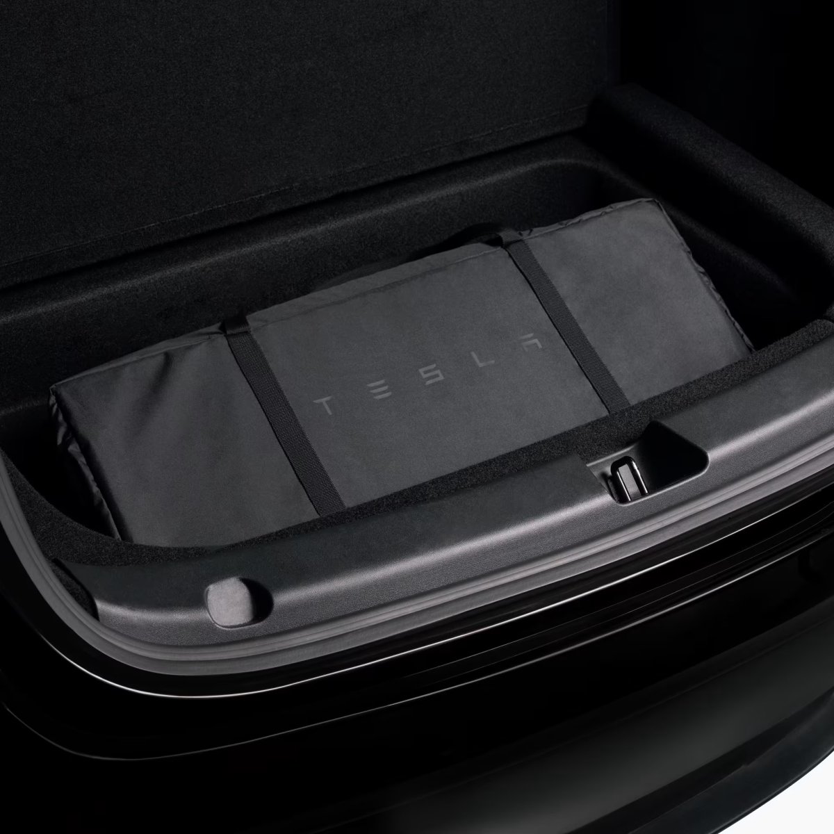 The folded up Model Y Air Mattress, in the sub-trunk.